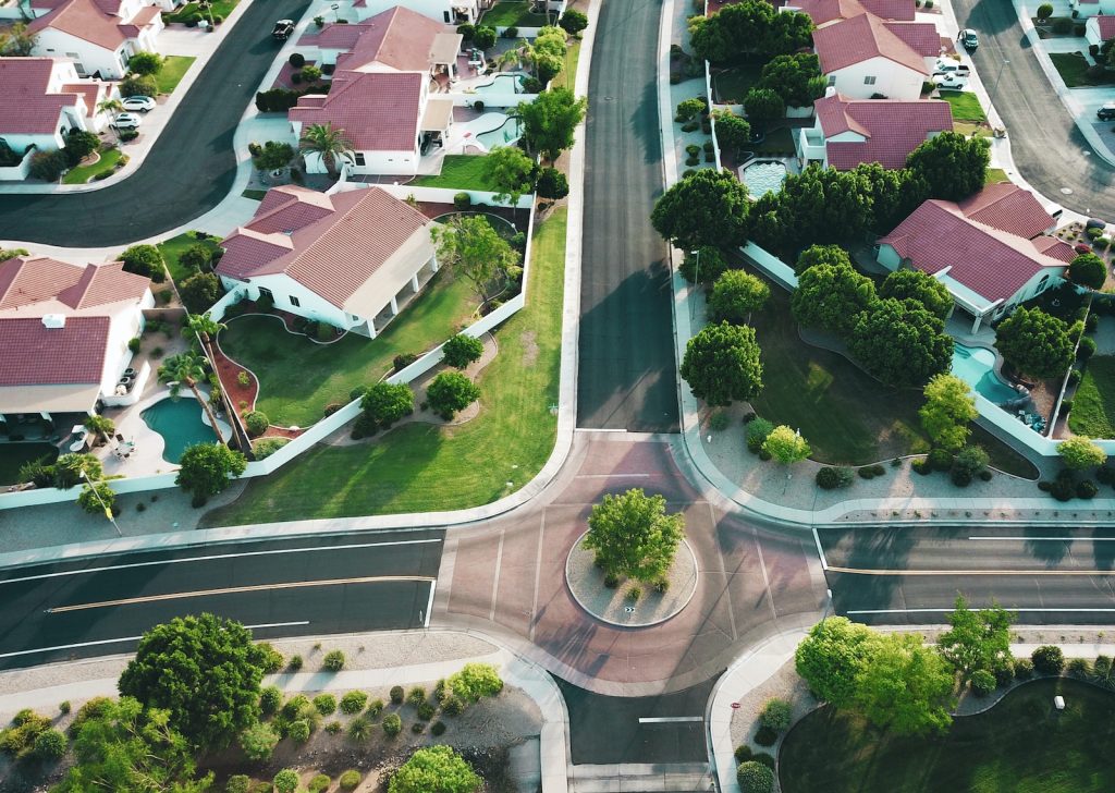 Roundabout in a neighbourhood of red and white houses with gardens
